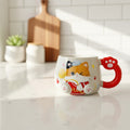 Keeyos PH cat paw mug with cute calico cat design, red handle, and yarn detail. Ceramic.