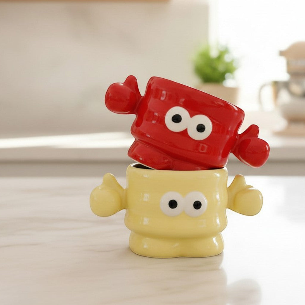 Keeyos PH red and yellow ceramic character mugs with googly eyes and thumbs up. Fun kitchenware.