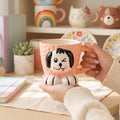 Keeyos PH pink ceramic mug with a winking dog face design and paw feet.