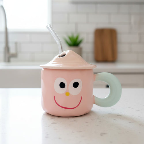 Keeyos PH pink ceramic mug with a light blue handle, featuring a smiling face and a glass straw.