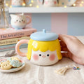 Keeyos PH Pippa Blushing Mug with yellow hair, blue lid, and pink handle. Features a cute face with rosy cheeks.