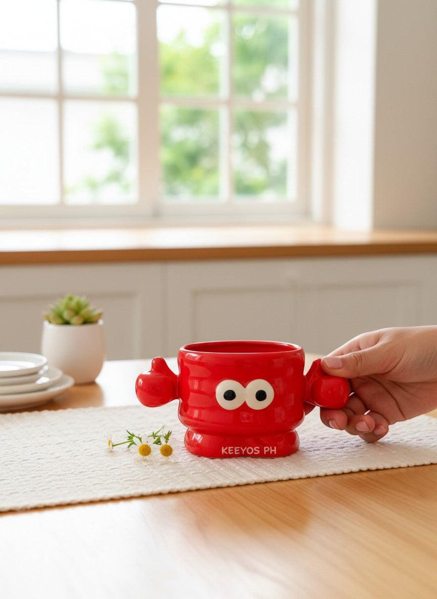 Keeyos PH red ceramic character mug with googly eyes and thumbs up design