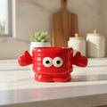 Keeyos PH red ceramic character mug with googly eyes and thumbs up, 12 oz