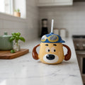 Keeyos PH yellow dog-shaped sippy cup with blue aviator hat and goggles, and a straw.
