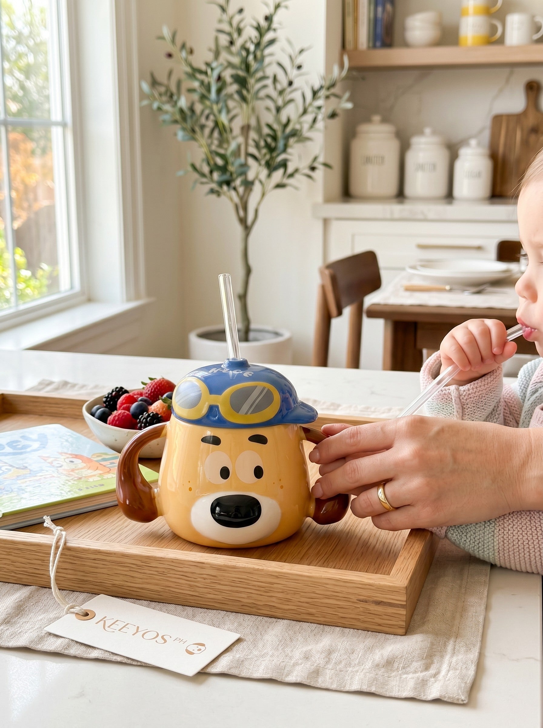 Keeyos PH yellow dog-shaped sippy cup with blue aviator hat and goggles, featuring brown ears and a straw.