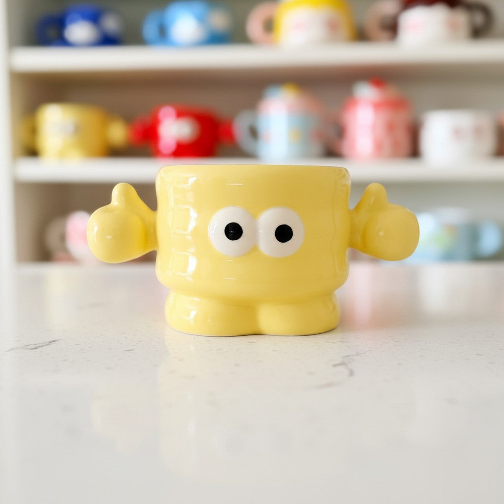 Keeyos PH yellow ceramic mug with cute character design, big eyes, and thumbs up. Perfect for coffee or tea.